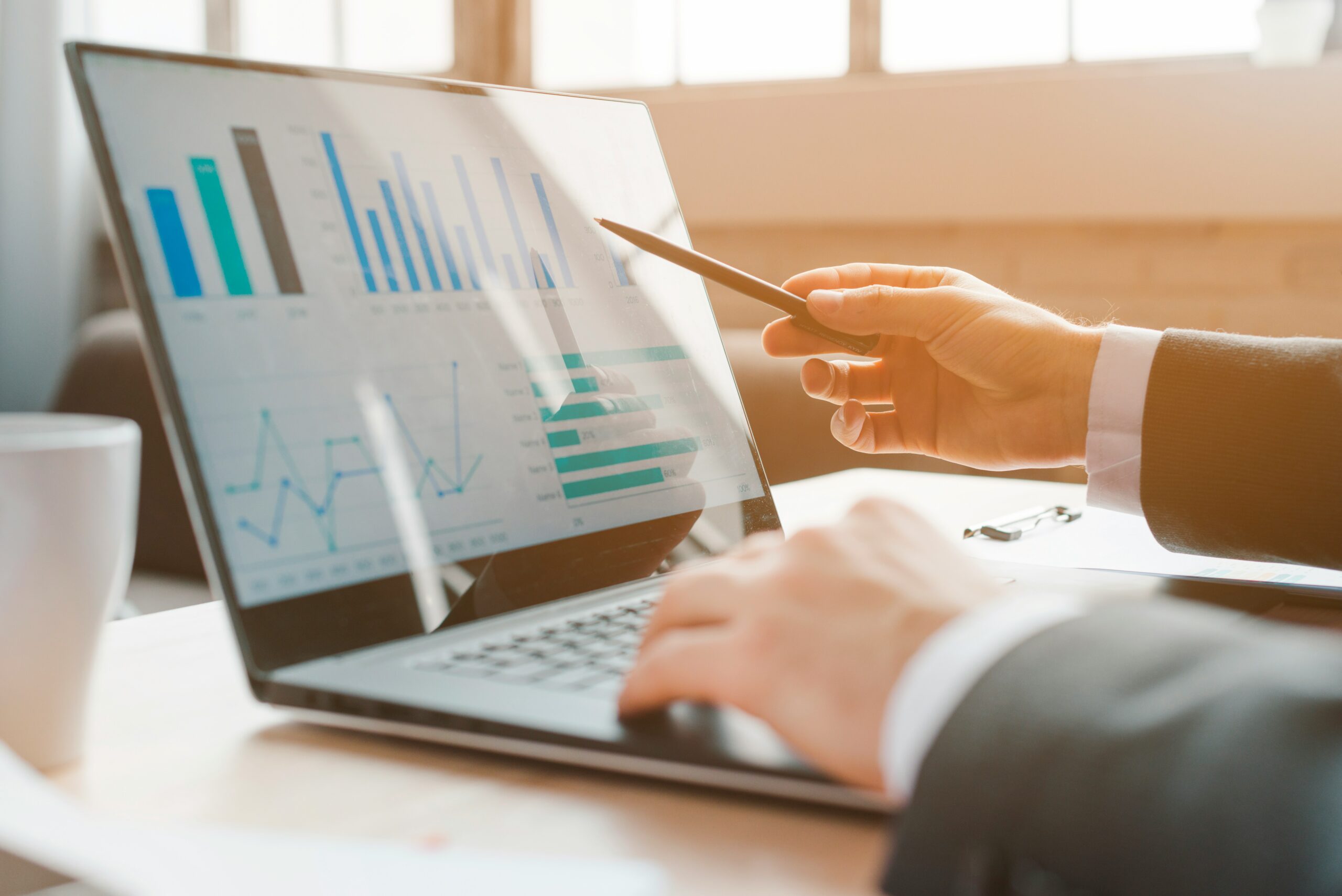 CFO analyzing financial charts and utility cost data on a laptop